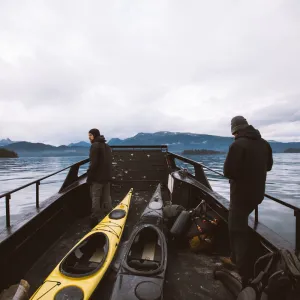 Two men at the front of the Cold Water Taxi vessel