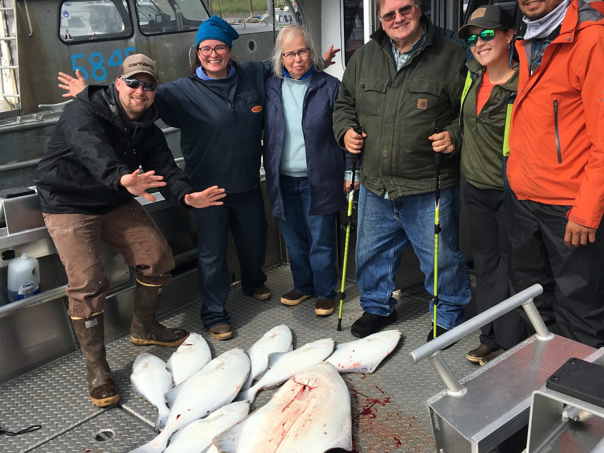 a group of people standing in front of a fish