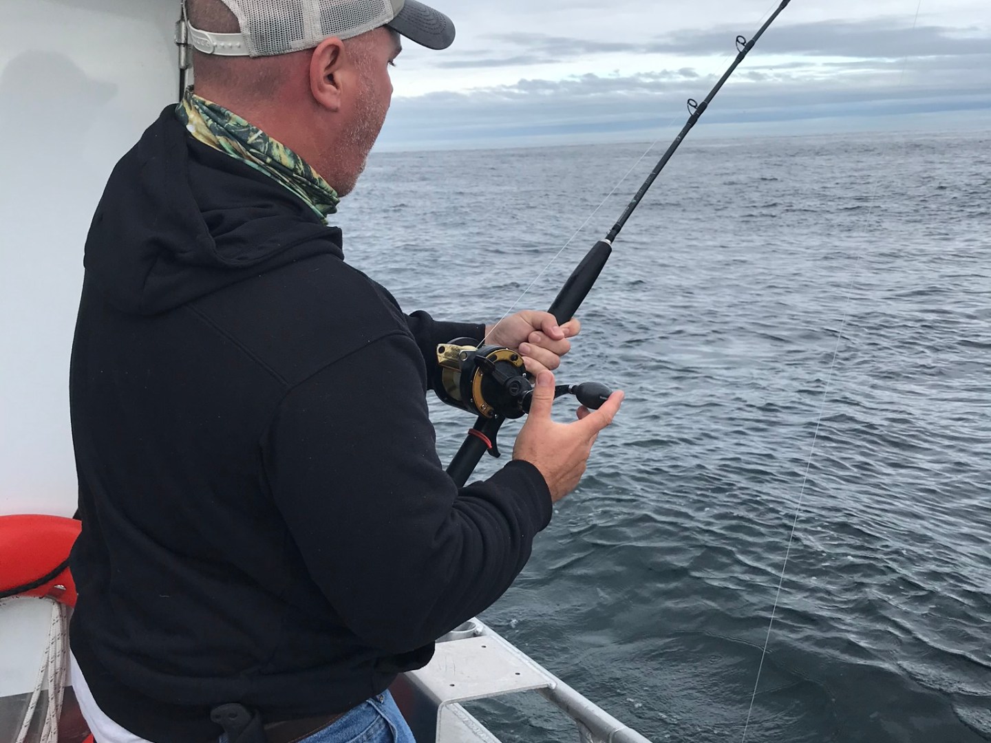 a man holding a kite in a boat on a body of water