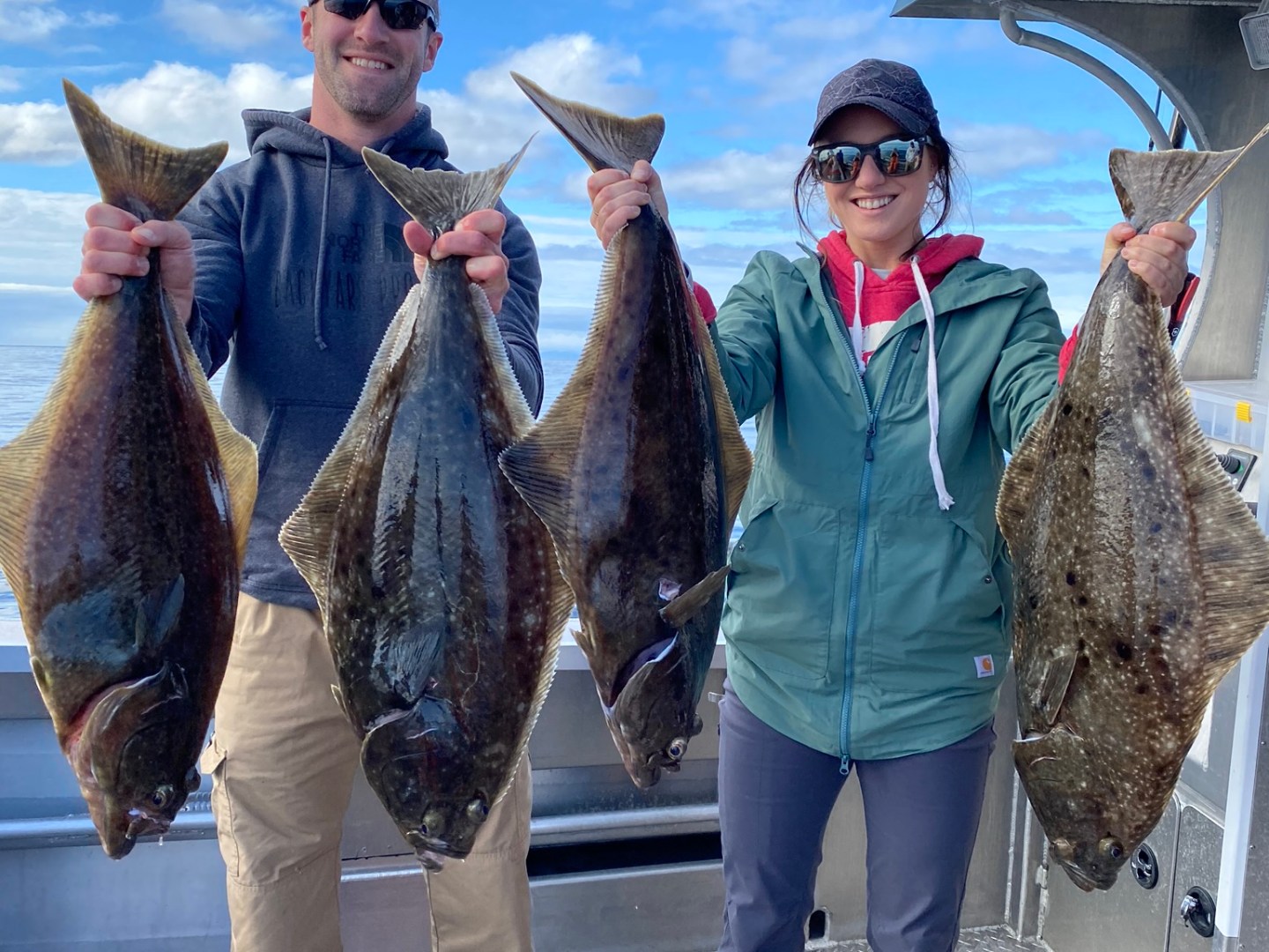 a group of people standing next to a person holding a fish
