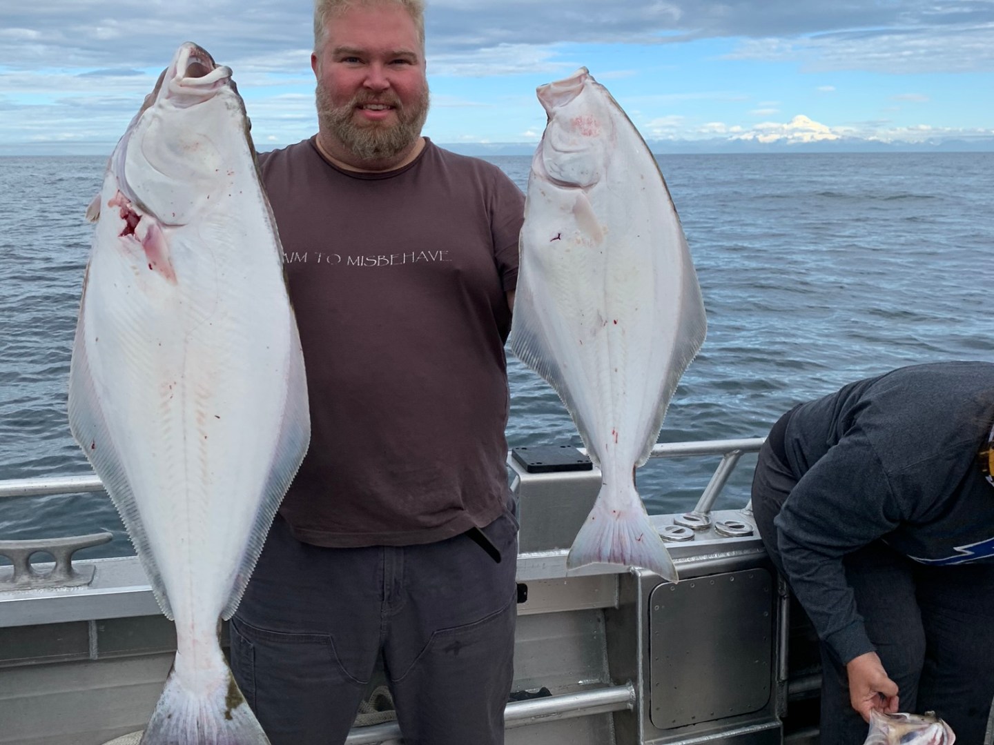 a person holding a fish in the water