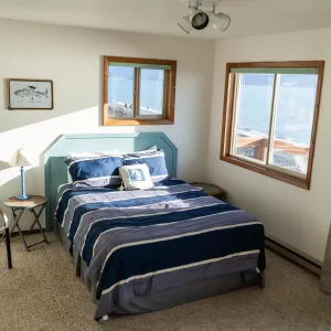 a bedroom with a bed and desk in a room