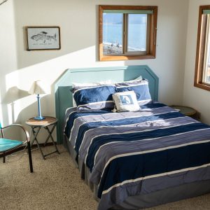 a bedroom with a bed and desk in a room