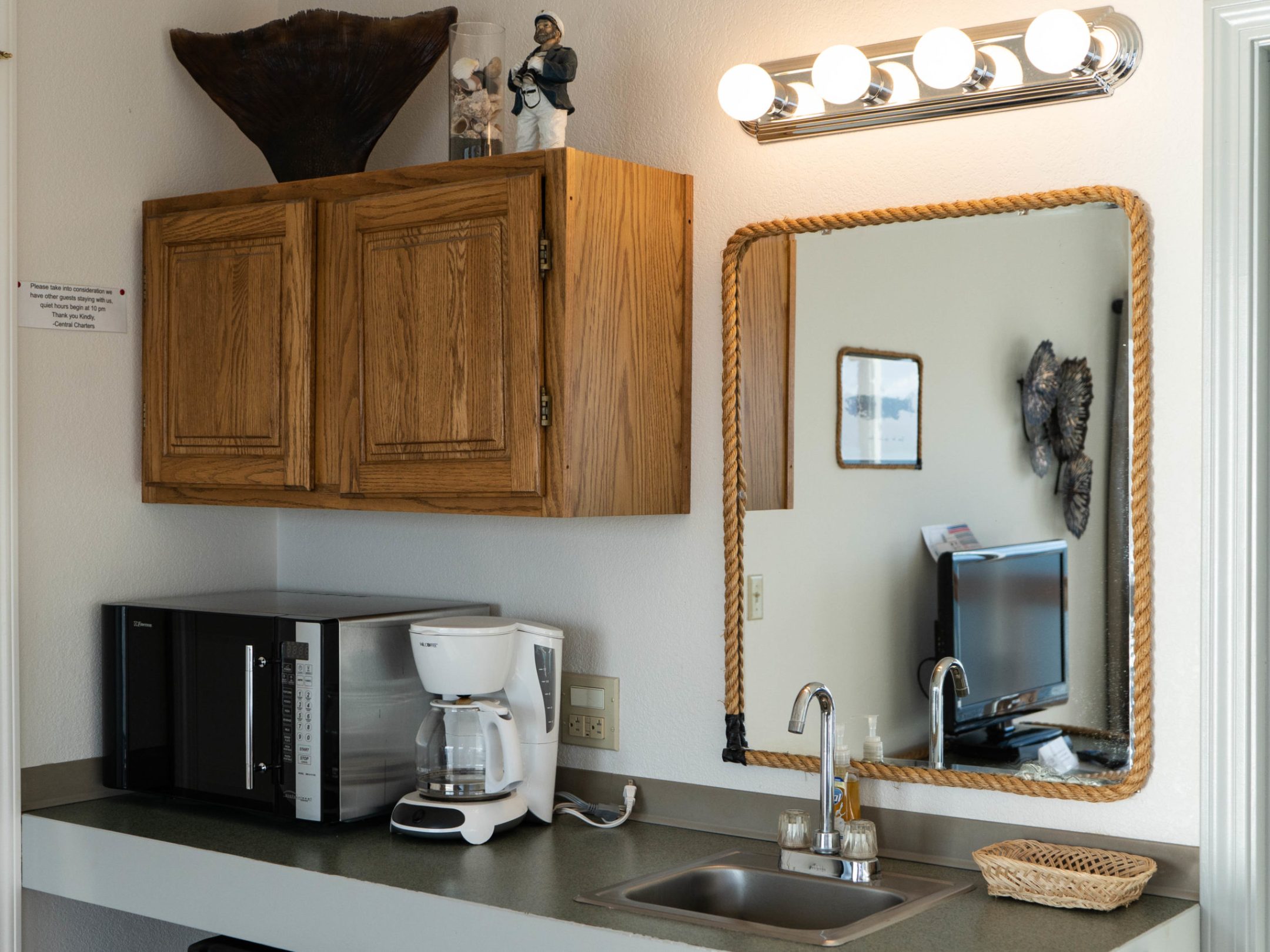 a kitchen with a sink and a mirror