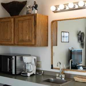 a kitchen with a sink and a mirror