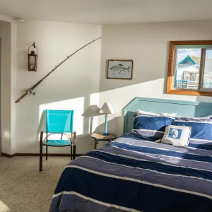 a bedroom with a bed and desk in a room