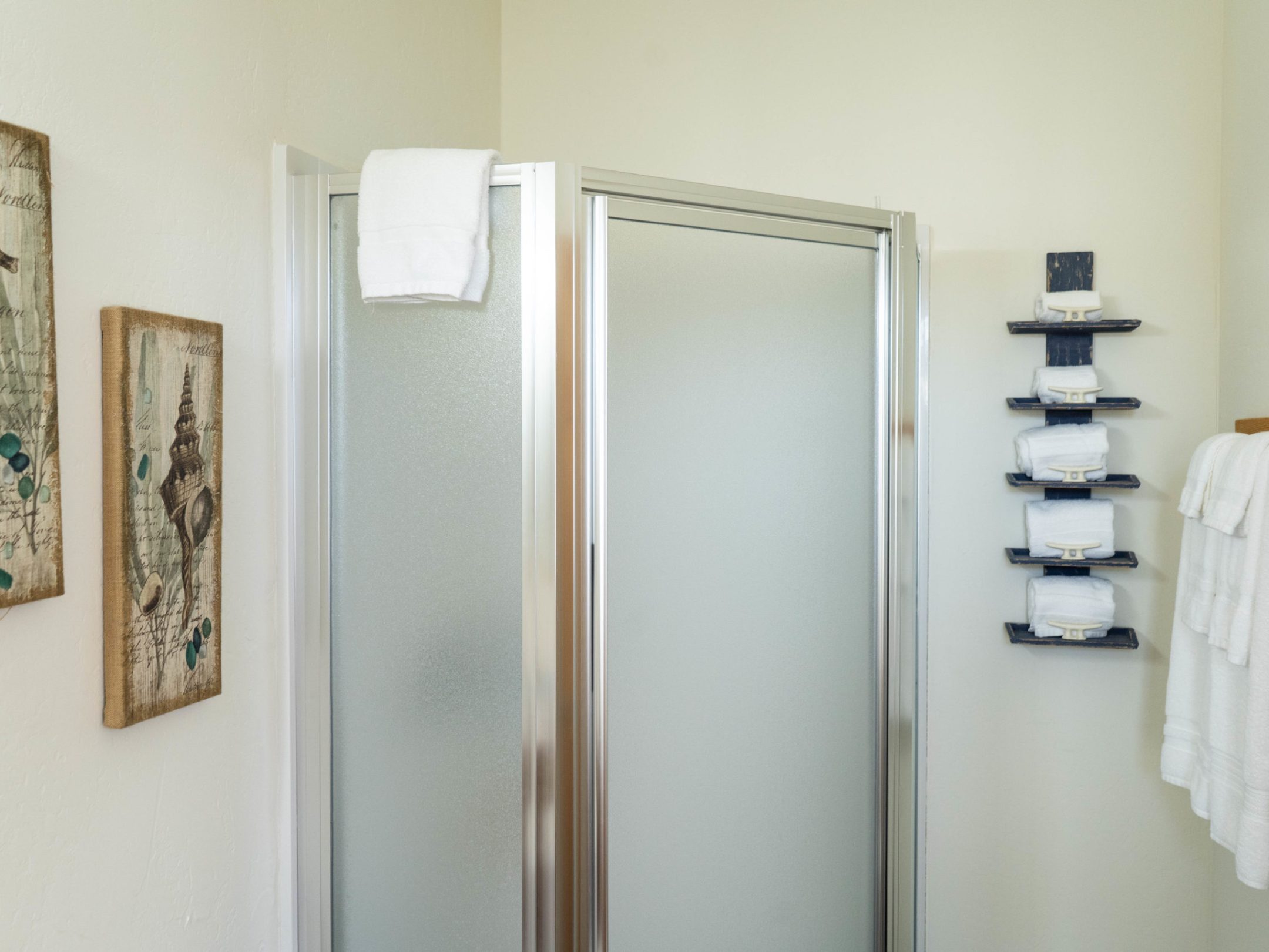 a shower with a towel hanging on the wall