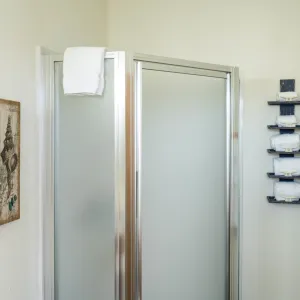 a shower with a towel hanging on the wall
