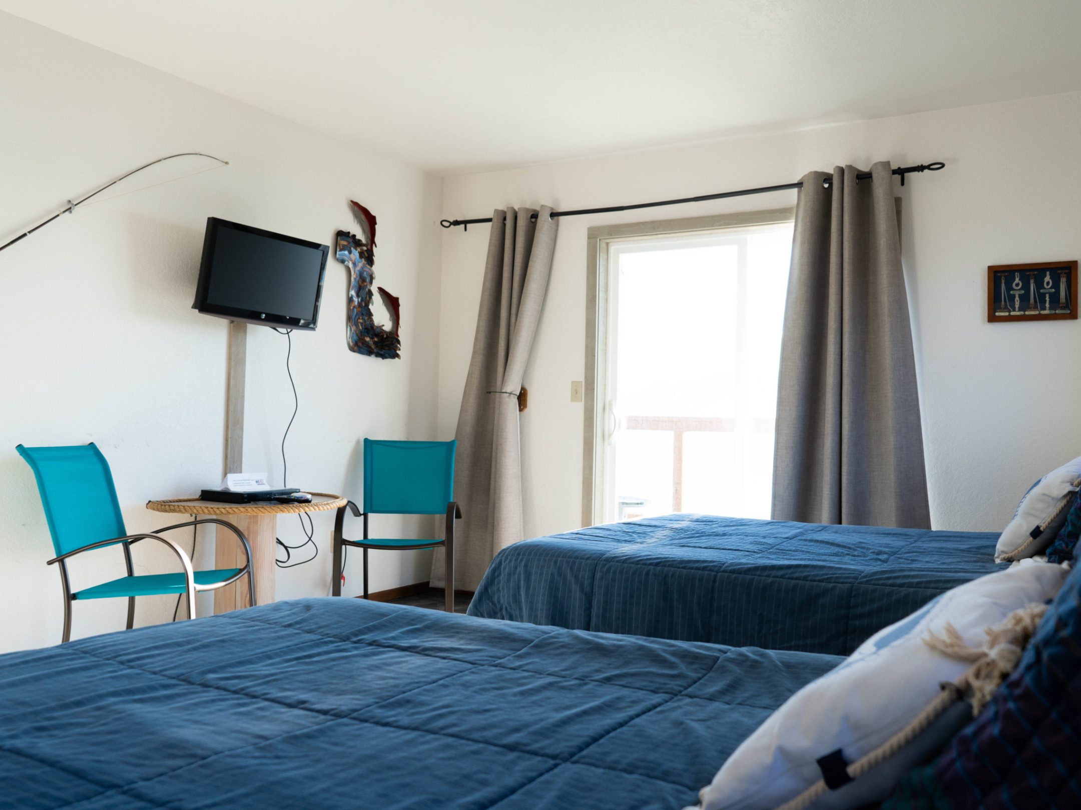 a bedroom with a bed and a chair in a room