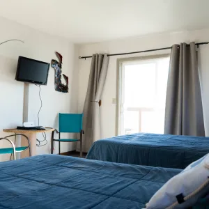 a bedroom with a bed and a chair in a room