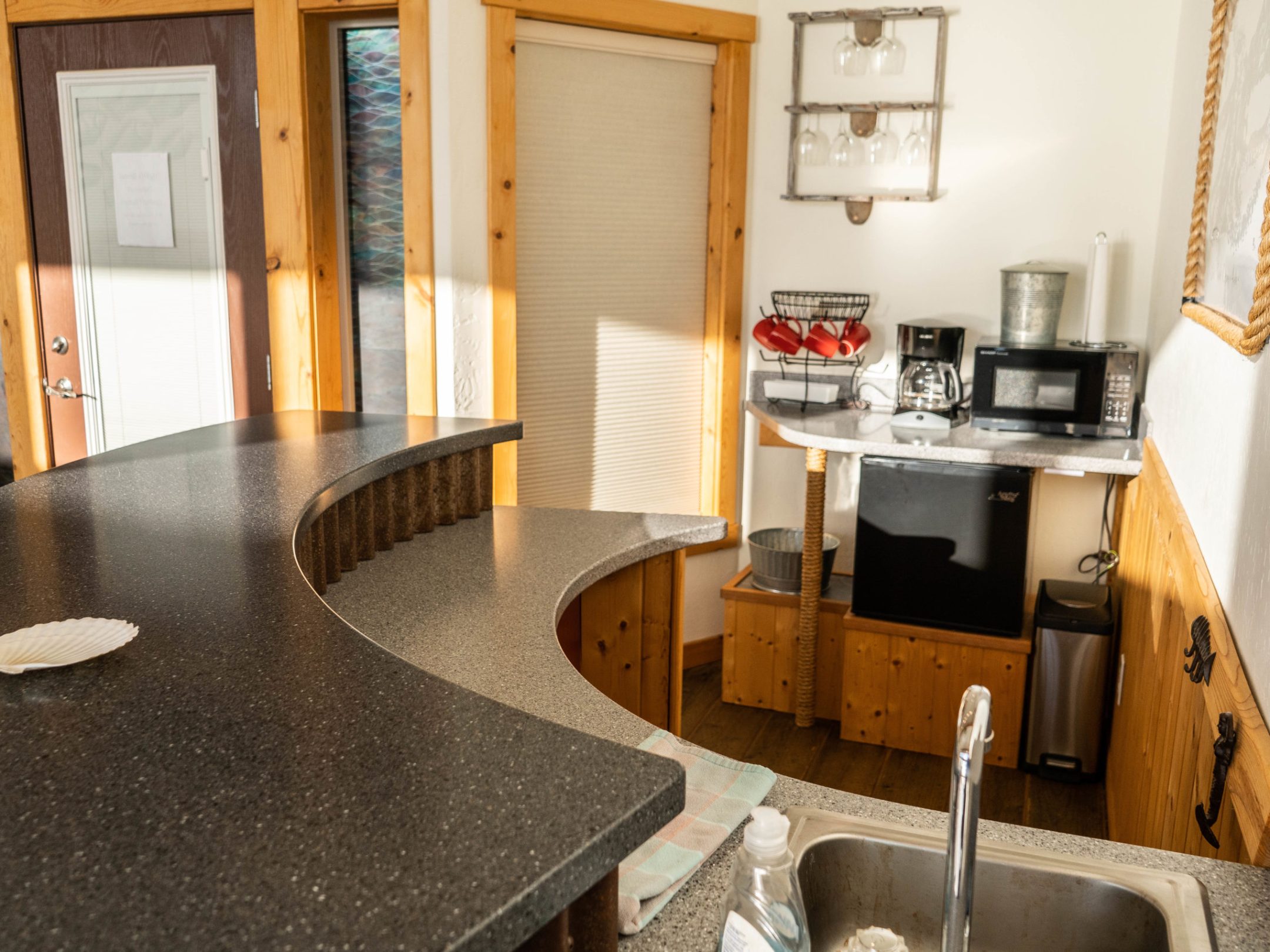 a kitchen with a sink and a dining table