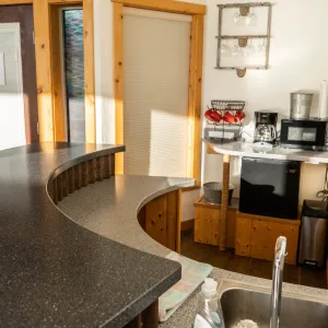 a kitchen with a sink and a dining table