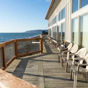 a wooden bench sitting next to a body of water