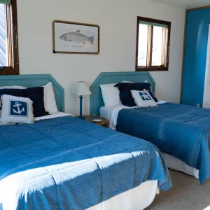a bedroom with a bed and a blue blanket