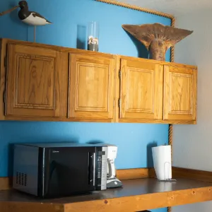 a kitchen with wooden cabinets and a microwave