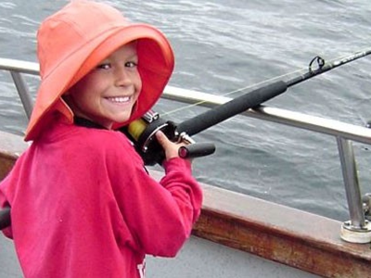 Little kid smiling while fishing