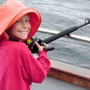 Little kid smiling while fishing