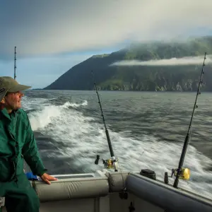 Man taking in the view on the back of the boat