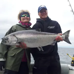 Man and woman holding salmon