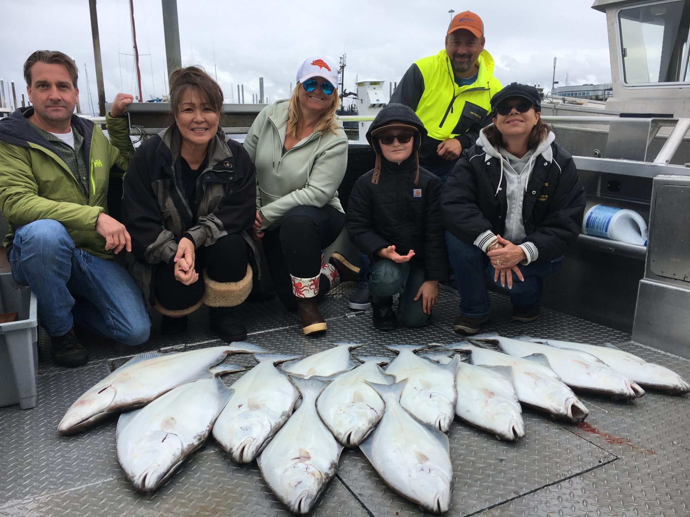 a group of people posing for a fish
