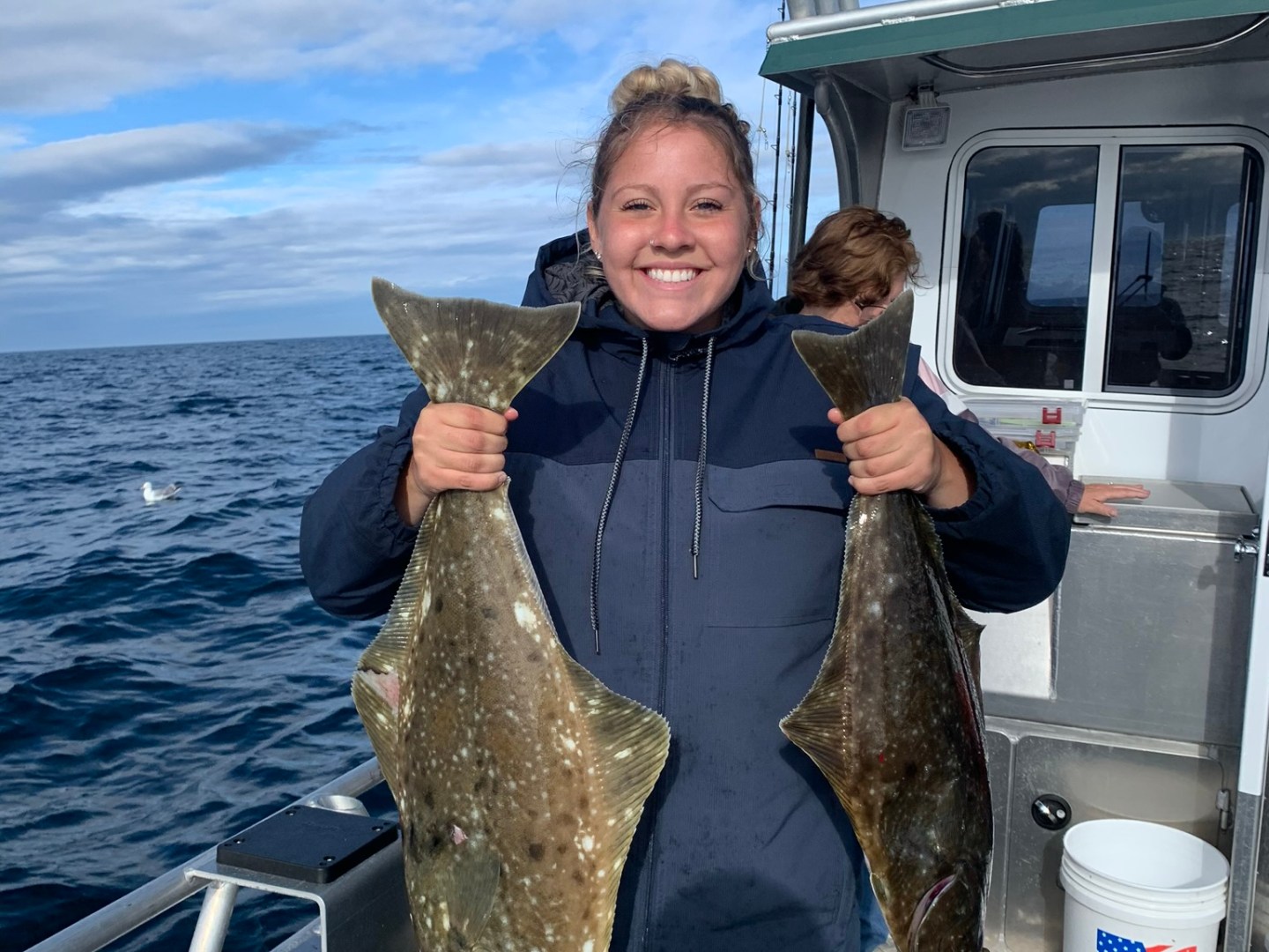 a woman standing in front of a body of water