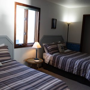 a bedroom with a bed and desk in a hotel room