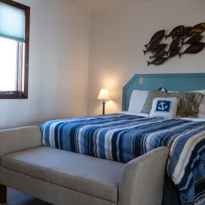 a bedroom with a bed and desk in a room