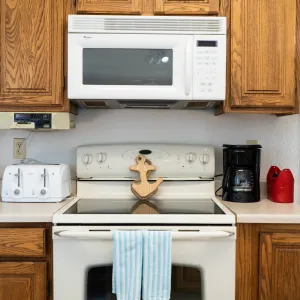 a kitchen with wooden cabinets and a microwave