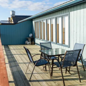 a wooden bench sitting in front of a building