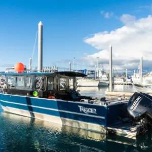 a boat is docked next to a body of water
