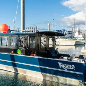 a boat is docked next to a body of water