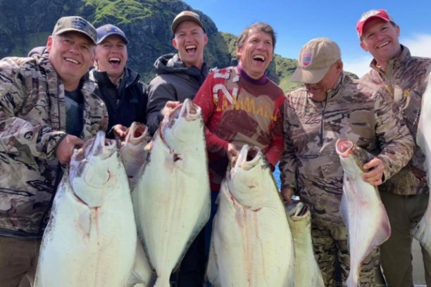 a group of people standing in front of a fish