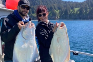 a person holding a fish in the water