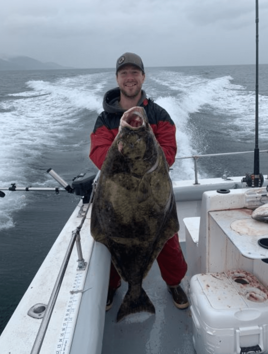a person holding a fish on a boat in the water